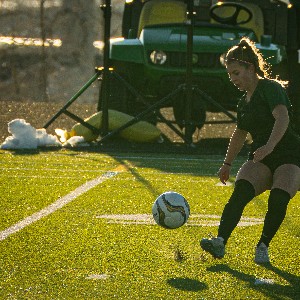 Soccer player kicks ball